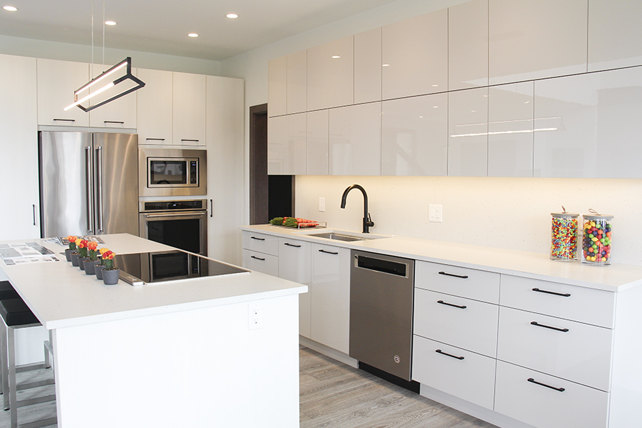 Contemporary kitchen with glossy white cabinets - 44 West Plains Drive in Sage Creek