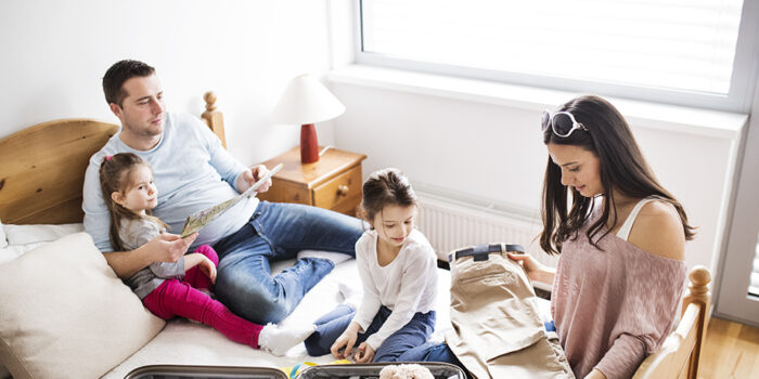 Young family with two children packing for holiday.